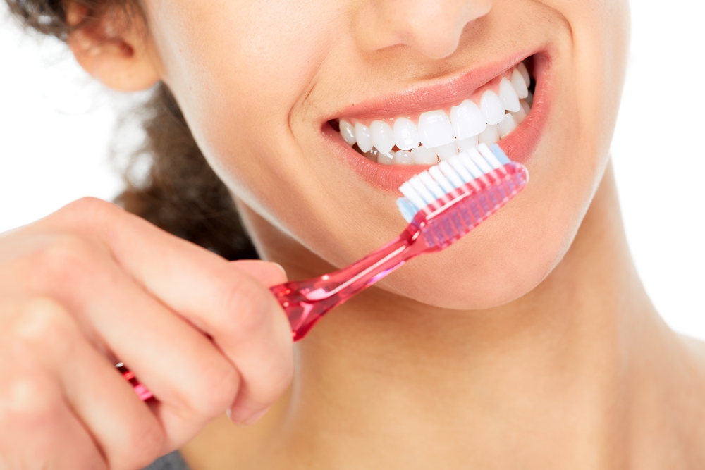 Woman Brushing Dental Implants