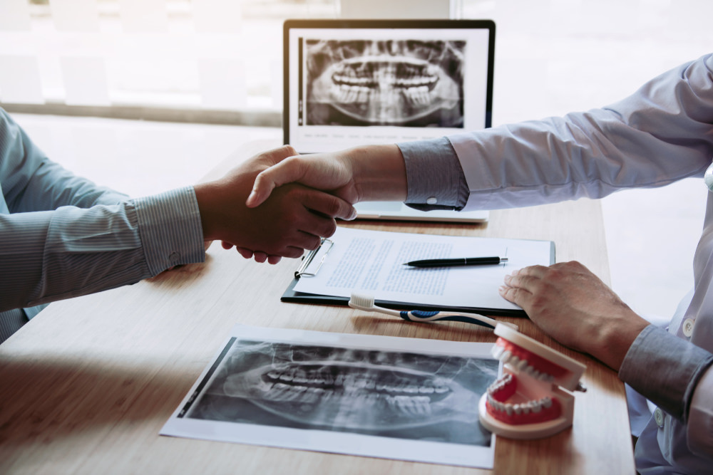 patient interviewing dental implant specialist